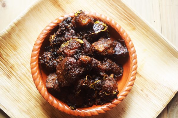 Lamb bhuna, slow-cooked off the bone in a rich dark masala