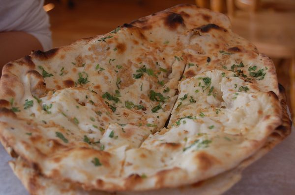 Fresh garlic naan, blistered from the tandoor and topped with coriander