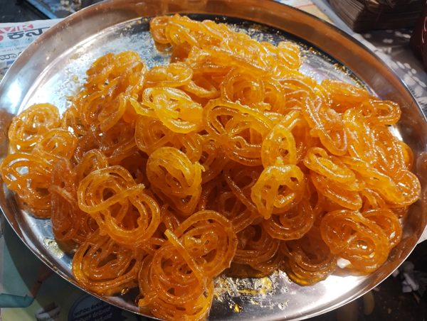 Fresh jalebi, crisp syrup-soaked spirals fried in Deshi Ghee